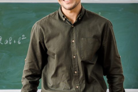 smiling-male-teacher-in-formal-wear-looking-at-cam-2NLG2E9.jpg