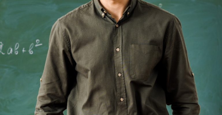 smiling-male-teacher-in-formal-wear-looking-at-cam-2NLG2E9.jpg